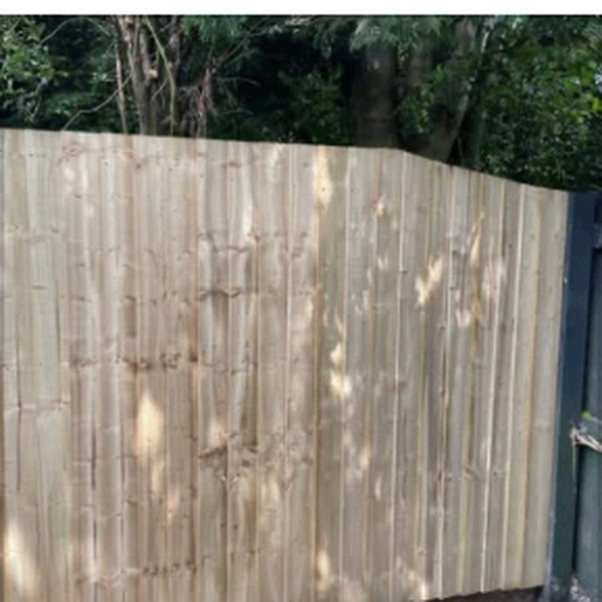 Curved top closeboard fence panels in a garden