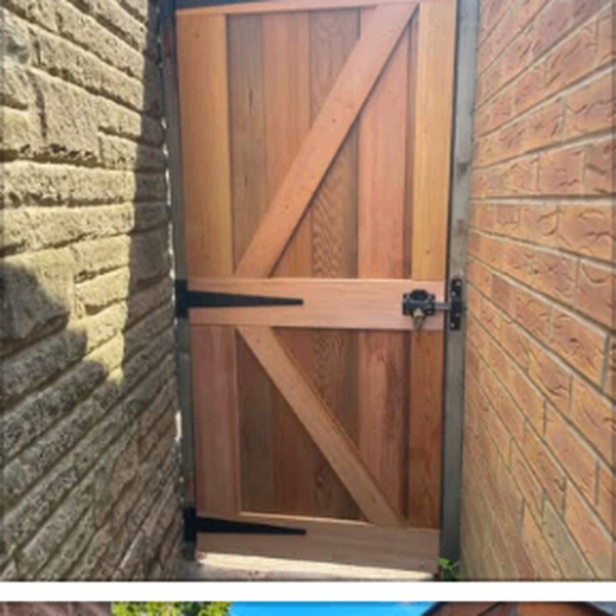 Braced timber gate hung in a brick opening