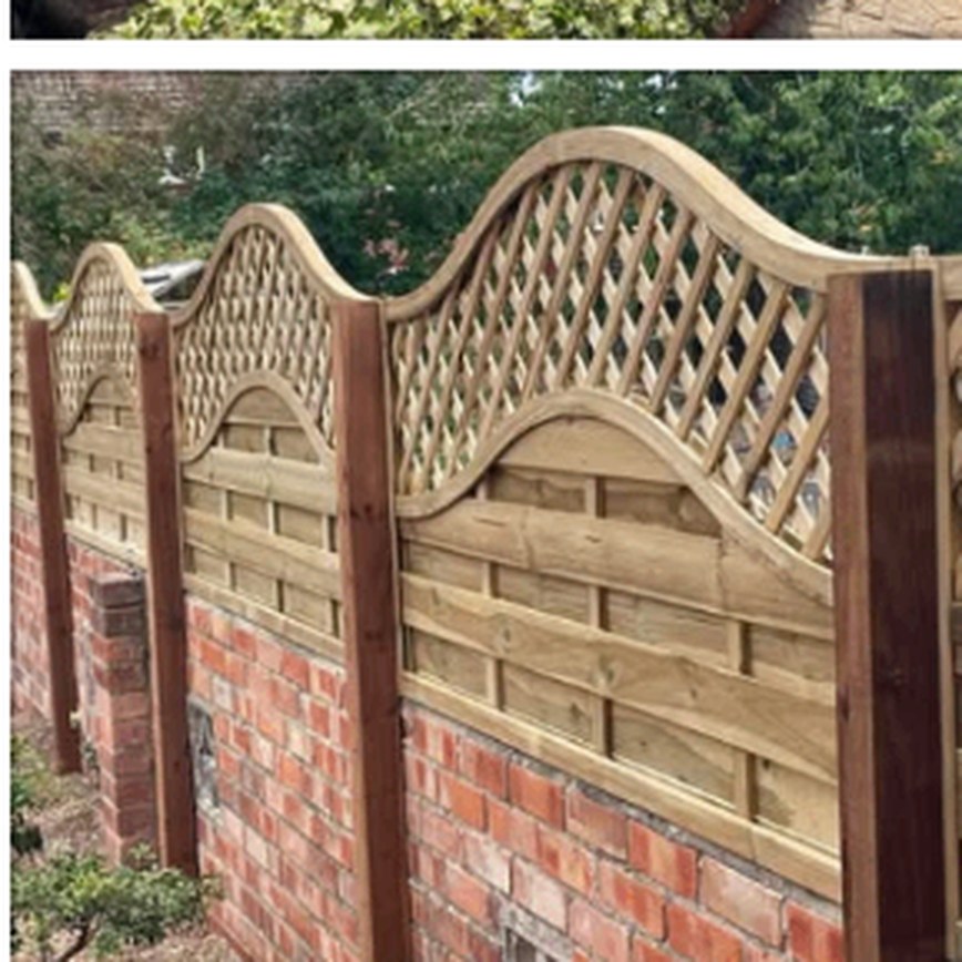 Wave lattice fence panels set on a brick garden wall