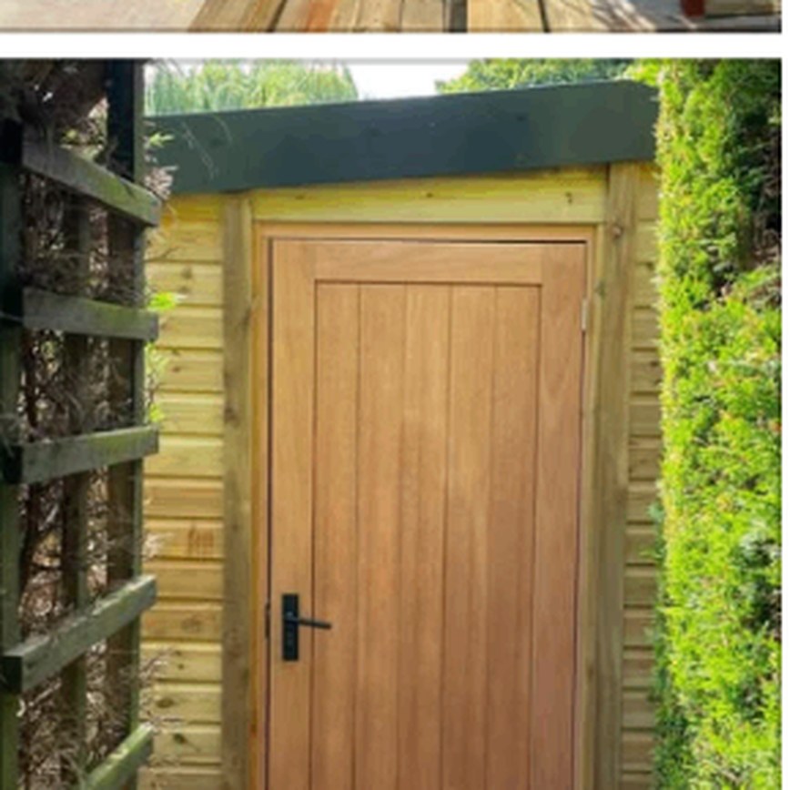 Bespoke timber shed with a solid timber door built beside a hedge