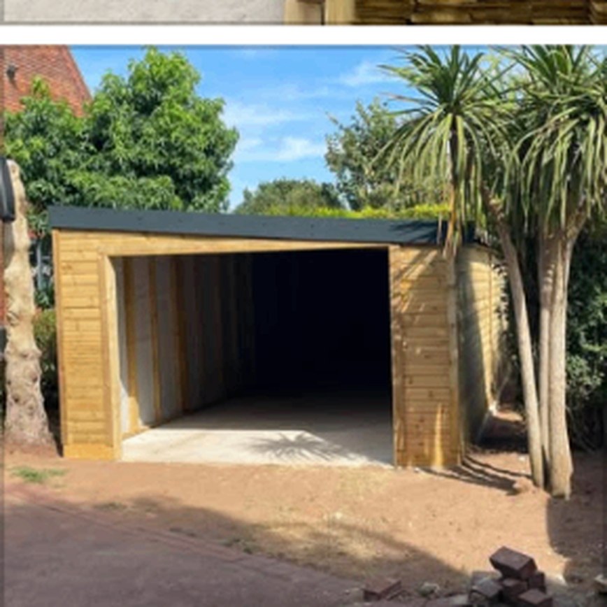 Large timber structure under construction in a driveway