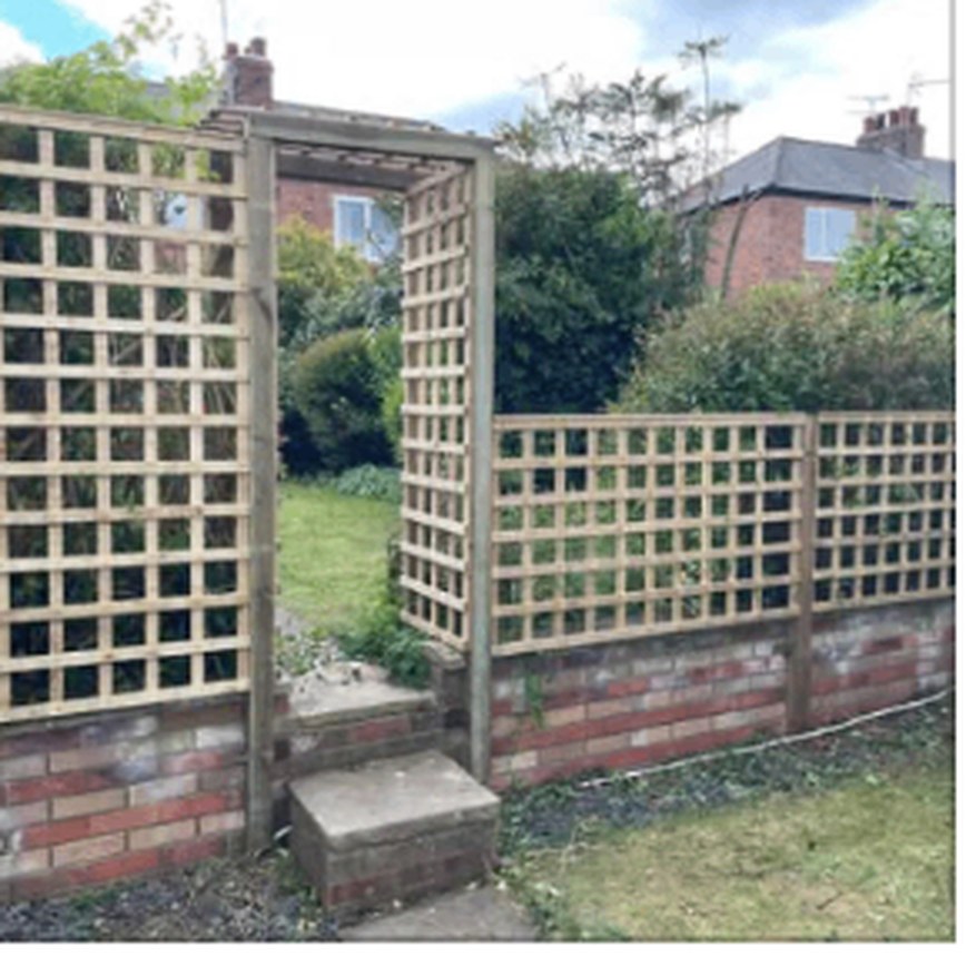 Timber trellis panels fixed above a garden wall