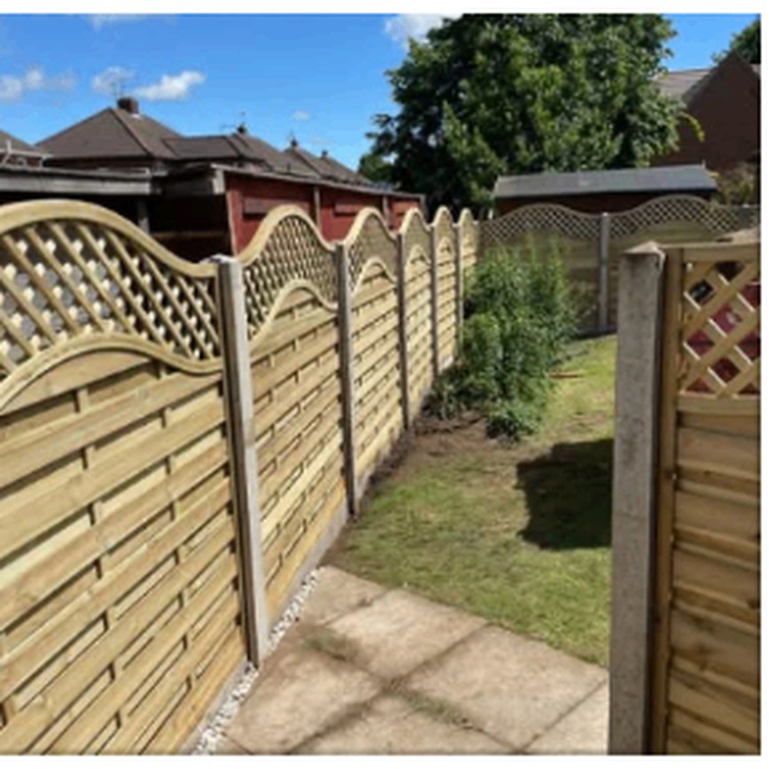 Wave lattice topped fence panels along a garden path